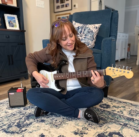 Carmen S. Collins playing guitar